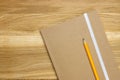 Wooden desk top with notebook and pencil Royalty Free Stock Photo