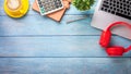 Wooden desk workplace with laptop, headphone, pen, calculator, notebook and cup of coffee. Royalty Free Stock Photo