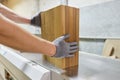 Wooden details in hands of male carpenter, woodworking industry Royalty Free Stock Photo