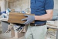 Wooden details in hands of male carpenter, woodworking industry Royalty Free Stock Photo