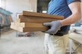 Wooden details in hands of male carpenter, woodworking industry Royalty Free Stock Photo