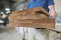 Wooden details in hands of male carpenter, woodworking industry Royalty Free Stock Photo