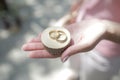 Wooden dice with wedding rings on a woman`s palm