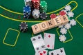 wooden dice on which writes poker playing cards and chips laid out on a poker table Royalty Free Stock Photo