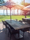 Wooden Dining Table And Chairs With Beach Umbrella With Sea View
