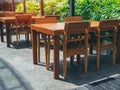 Wooden dining table set near the green garden Royalty Free Stock Photo