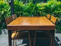 Wooden dining table set near the green garden Royalty Free Stock Photo