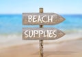 Wooden direction sign with beach supplies Royalty Free Stock Photo