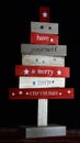 Wooden directional boards with Christmas saying written on them