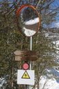 Wooden Directional Signs for Walks, Warning Sign and Parabolic Road Mirror in the Italian Mountains Royalty Free Stock Photo