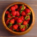 Wooden dish with strawberries. wood background, view from the top, square