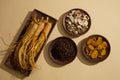 Wooden dishes featured ginseng roots, cloves, dried turmeric slices and sand ginger.