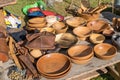 Wooden dishes and leather products on the table of the village shop.