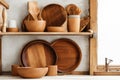 Assortment of wooden plates dishes kitchen utensils on wooden background