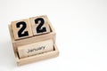 Wooden display block with January 22nd lettering on white background