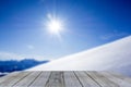 Wood display shelf winter table top against snow mountain panorama blue sky Royalty Free Stock Photo