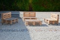 Wooden diy lounge bench and table made of construction wooden pallets stylish on house private garden terrace