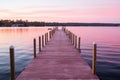 a wooden dock extends into the water at sunset