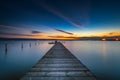 Wooden Dock and fishing boat at the lake, sunset shot Royalty Free Stock Photo