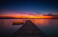 Wooden Dock and fishing boat at the lake, sunset shot Royalty Free Stock Photo