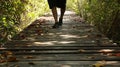 Man Walking on Wooden Path in Forest Royalty Free Stock Photo