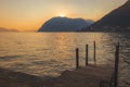 Wooden dock on Lake Iseo at sunset Royalty Free Stock Photo