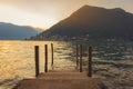 Wooden dock on Lake Iseo at sunset. Sulzano, Lombardy, Italy. Royalty Free Stock Photo