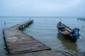 Wooden dock with old motor boat in the sea Royalty Free Stock Photo