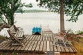 Wooden dock pier with wooden chairs on cottage lake in Muskoka Ontario Canada. Cottage countryside rural authentic life. Travel