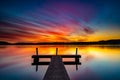 Wooden dock on the sea with long exposure during a breathtaking sunset in the evening