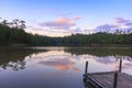 Wooden dock on serene lake with sunset