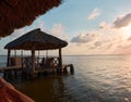 wooden dock with thatched roof, traditional Mexican design in the summer sunset with the lake of Old Town city in the background