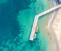 Wooden dock and two boats with blue sea. Aerial drone view of beautiful sea and beach Royalty Free Stock Photo