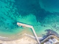 Wooden dock and two boats with blue sea. Aerial drone view of beautiful sea and beach Royalty Free Stock Photo