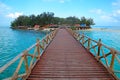 Wooden dock walkway to tropical island