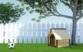 Wooden dog kennel under tree shade on green grass meadow with soccer ball and white wooden fence Royalty Free Stock Photo