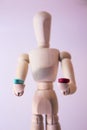 Wooden doll holding two pills. Royalty Free Stock Photo