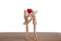 A wooden doll man in a valentine theme show his love to his couple