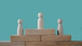 Wooden dolls placed on wooden blocks are a Successful business team leader concept