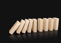 Wooden domino blocks falling down in sequence