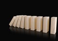 Wooden domino blocks falling down in sequence