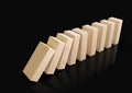 Wooden domino blocks falling down in sequence