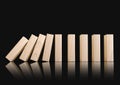 Wooden domino blocks falling down in sequence