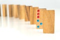 Wooden dominoes standing in a row