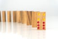 Wooden dominoes standing in a row