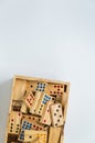 Wooden dominos in wooden box on white background with selective focus Royalty Free Stock Photo