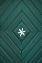 Old dark green wooden door with ornaments Royalty Free Stock Photo