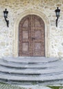 Wooden door with arch on stone wall Royalty Free Stock Photo