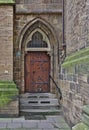 Wooden door with archway and steps Royalty Free Stock Photo