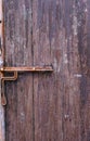 Wooden door in Bali with rusted iron bolt and handle Royalty Free Stock Photo